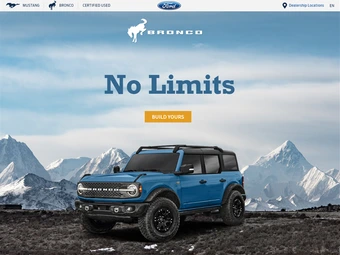 website screenshot of Ford Bronco sitting on hill with mountains in background